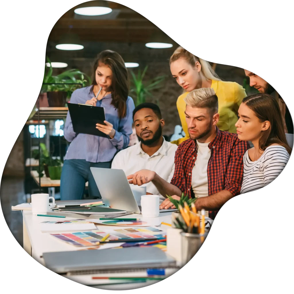 Marketing agency team collaborating and discussing strategy in modern office