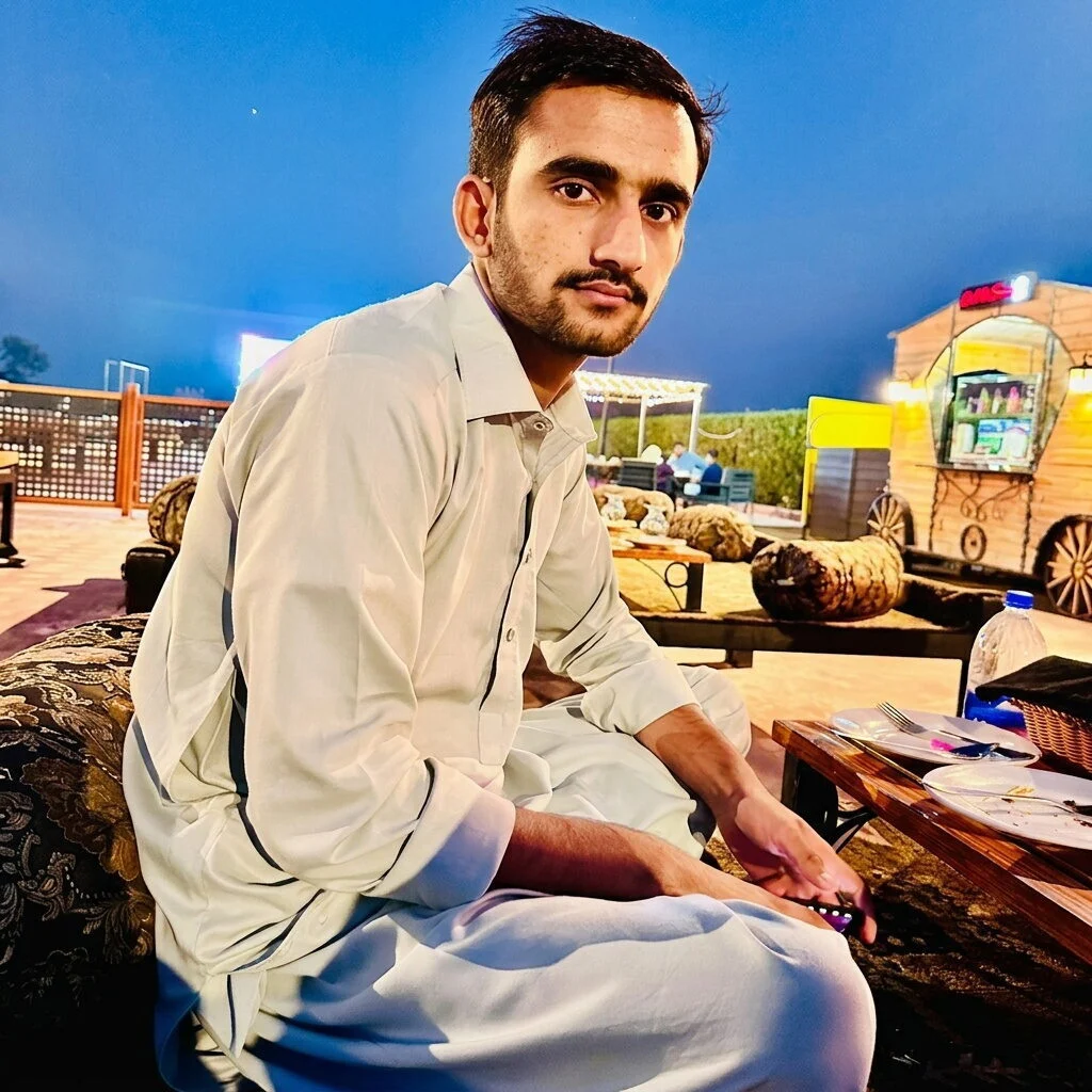man in casual pose with food on table portrait